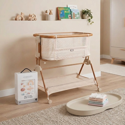 Baby bassinet with folded blankets on a tray in a nursery setting